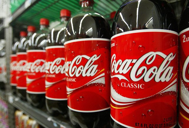 SAN FRANCISCO - JANUARY 16: Bottles of Coca-Cola are seen on the shelf at Tower Market January 16, 2004 in San Francisco, California. Coca-Cola is being investigated by U.S. regulators over allegations raised by a former employee that it had inflated its earnings. (Photo by Justin Sullivan/Getty Images)