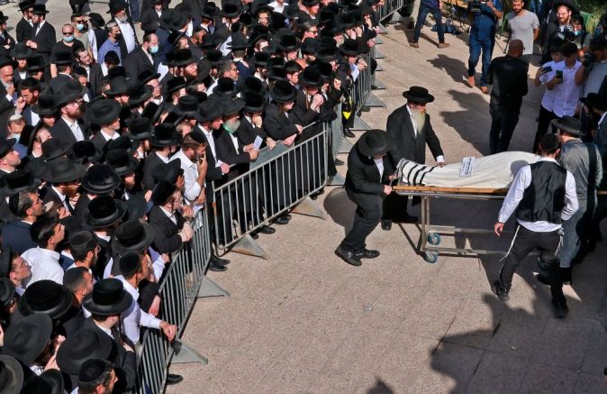  Ultra-Orthodox Jewish men take part in a funeral ceremony in Jerusalem for a victim of an overnight stampede during a religious gathering in northern Israel, on April 30, 2021. - A massive stampede at a densely packed Jewish pilgrimage site killed at least 44 people in Israel, blackening the country's largest COVID-era gathering. (Photo by Menahem KAHANA / AFP) (Photo by MENAHEM KAHANA/AFP via Getty Images)
