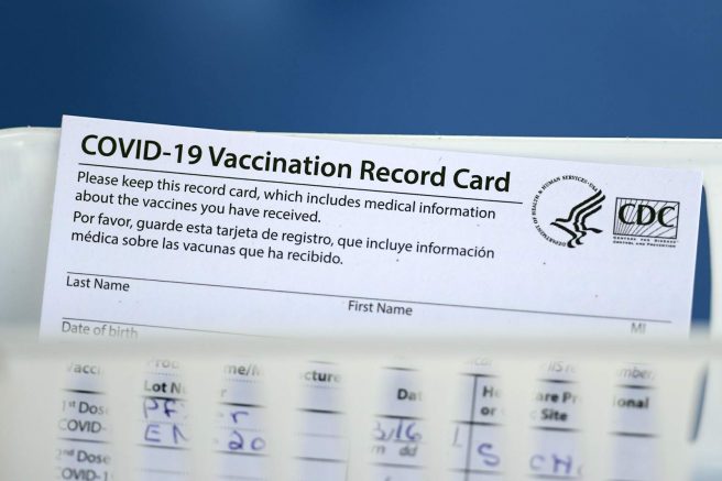 A vaccination record card is shown during a COVID-19 vaccination drive for Spring Branch Independent School District education workers Tuesday, March 16, 2021, in Houston. School employees who registered were given the Pfizer vaccine.(AP Photo/David J. Phillip)