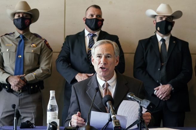 A masked Texas Gov Greg Abbott speaks at a news conferenced about migrant children detentions Wednesday, March 17, 2021, in Dallas. (AP Photo/LM Otero)