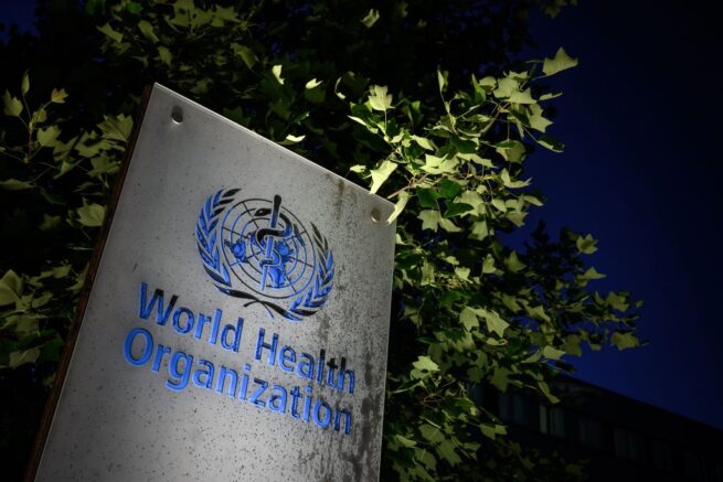 TOPSHOT - A photo taken in the late hours of May 29, 2020 shows a sign of the World Health Organization (WHO) at their headquarters in Geneva amid the COVID-19 outbreak, caused by the novel coronavirus. - President Donald Trump said May 29, 2020, he was breaking off US ties with the World Health Organization, which he says failed to do enough to combat the initial spread of the novel coronavirus. (Photo by Fabrice COFFRINI / AFP) (Photo by FABRICE COFFRINI/AFP via Getty Images)