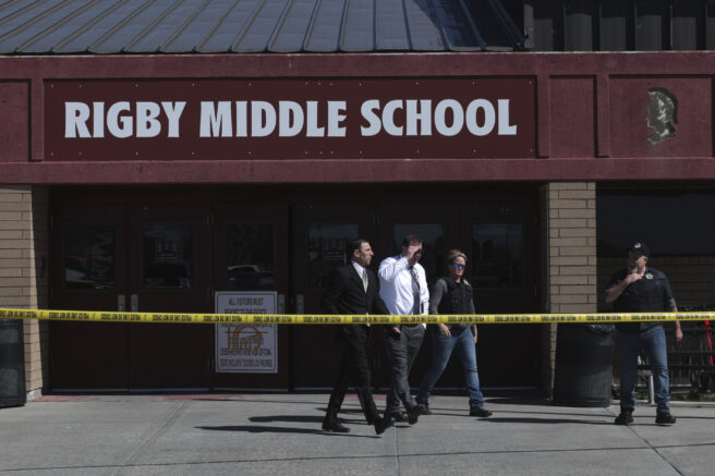 Officers leave Rigby Middle School after a shooting in Rigby, Idaho on Thursday, May 6, 2021. Authorities say a shooting at the eastern Idaho middle school has injured two students and a custodian, and a female student has been taken into custody. (John Roark /The Idaho Post-Register via AP)