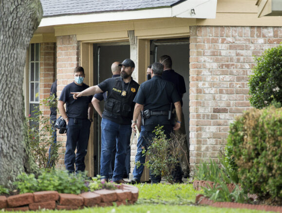  Law enforcement officials investigate the site of a human smuggling case, where more than 90 undocumented immigrants were found inside a home on the 12200 block of Chessington Drive on Friday, April 30, 2021, in Houston. A Houston Police officials said the case will be handled by federal authorities. ( Godofredo A. Vásquez/Houston Chronicle via AP)