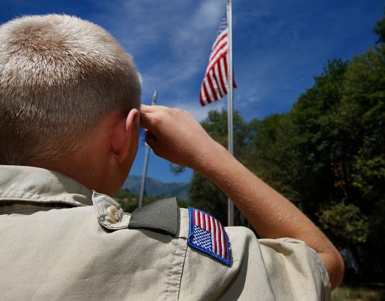 PAYSON, UT - JULY 31: A Boy Scout salutes the American flag at camp Maple Dell on July 31, 2015 outside Payson, Utah. The Mormon Church is considering pulling out of its 102 year old relationship with the Boy Scouts after the Boy Scouts changed it's policy on allowing gay leaders in the organization. Over 99% of the Boy Scout troops in Utah are sponsored by the Mormon Church. (Photo by George Frey/Getty Images)