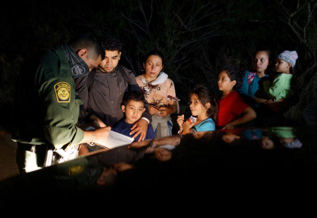 ROMA, TEXAS - APRIL 27 - A U.S. Border Patrol agent registers immigrants after they crossed the Rio Grande from Mexico on April 27, 2021 in Roma, Texas. A surge of mostly Central American immigrants crossing into the United States, including record numbers of children, has challenged U.S. immigration agencies along the U.S. southern border. (Photo by John Moore/Getty Images)