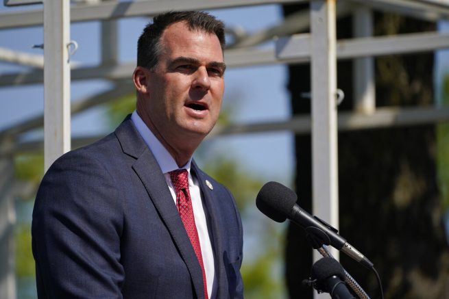 Oklahoma Gov. Kevin Stitt speaks during an Oklahoma Law Enforcement Memorial Ceremony Friday, May 7, 2021, in Oklahoma City. The names of 11 fallen officers have been added to the Oklahoma Law Enforcement Memorial in addition to one K-9 who died in the line of duty. (AP Photo/Sue Ogrocki)
