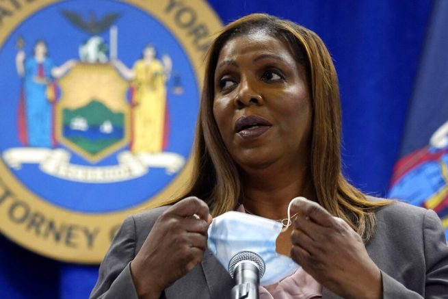 New York Attorney General Letitia James removes her mask at the beginning of a news conference at her office, in New York, Friday, May 21, 2021. James said Friday that she's assigned two lawyers to work with the Manhattan district's attorney's office on a criminal investigation into former President Donald Trump's business dealings. (AP Photo/Richard Drew)