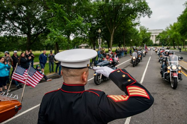 WASHINGTON, DC - MAY 30: Staff Sgt. Tim Chambers salutes as motorcyclists participate in the "Rolling to Remember" motorcycle rally as they ride past the Lincoln Memorial on May 30, 2021 in Washington, DC. The ride was to raise awareness of the critical issues facing the nation's veterans. (Photo by Tasos Katopodis/Getty Images)