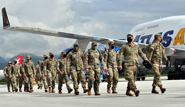 US soldiers disembark the Boeing 747-400 "Atlas Air" upon their arrival at Sarajevo International Airport on May 15, 2021. - American soldiers arrived in Sarajevo on a civilian plane from the USA, flying over Germany, and were immediately escorted by members of the Military Police of the Armed Forces of Bosnia and Herzegovina to the training ground of the AF BiH Manjaca. A total of about 500 members of the AF BiH and about 700 American soldiers will participate in the exercise "Quick Response 21" at the Glamoc, Manjaca training grounds and the barracks and Dubrava airport near Tuzla. (Photo by ELVIS BARUKCIC / AFP) (Photo by ELVIS BARUKCIC/AFP via Getty Images)