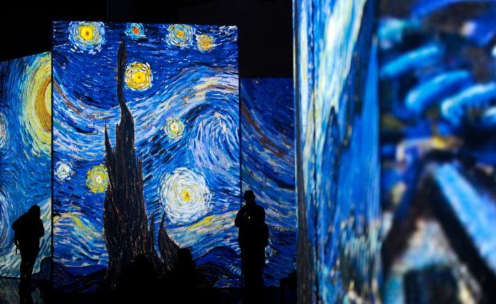 People visit the exhibition "Van Gogh Alive - The Experience", life and work of Vincent Van Gogh from 1880 until 1890 on February 02, 2018 in Sevilla. Photographs and videos combined with a unique system that incorporates over 50 high-definition projectors, graphics and multi-channel surround sound to create multi-screen environments showing the art of Vincent Van Gogh. / AFP PHOTO / CRISTINA QUICLER / RESTRICTED TO EDITORIAL USE - MANDATORY MENTION OF THE ARTIST UPON PUBLICATION - TO ILLUSTRATE THE EVENT AS SPECIFIED IN THE CAPTION (Photo credit should read CRISTINA QUICLER/AFP via Getty Images)