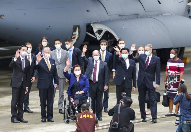 Taiwan's Foreign Minister Joseph Wu, fourth from right, waves with U.S. senators to his right Democratic Sen. Christopher Coons of Delaware, a member of the Foreign Relations Committee, Democratic Sen. Tammy Duckworth of Illinois and Republican Sen. Dan Sullivan of Alaska, members of the Armed Services Committee on their arrival at the Songshan Airport in Taipei, Taiwan on Sunday, June 6, 2021. The bipartisan group of three U.S. senators arrived in Taiwan to meet with senior government officials and discuss U.S.-Taiwan relations and other issues in a trip that is likely to anger China, which claims Taiwan as its territory and objects to Taiwan being called a country. (Pool Photo via AP)