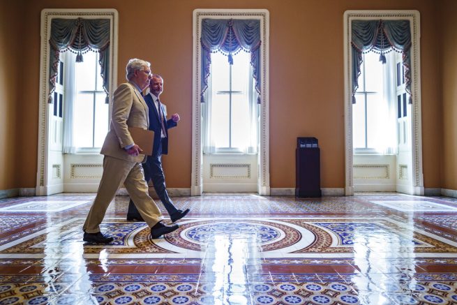 Senate Minority Leader Mitch McConnell, R-Ky., accompanied by Robert Duncan, the secretary for the minority, walks to the chamber as the Senate resumes work following a ten-day recess, at the Capitol in Washington. (AP Photo/J. Scott Applewhite)