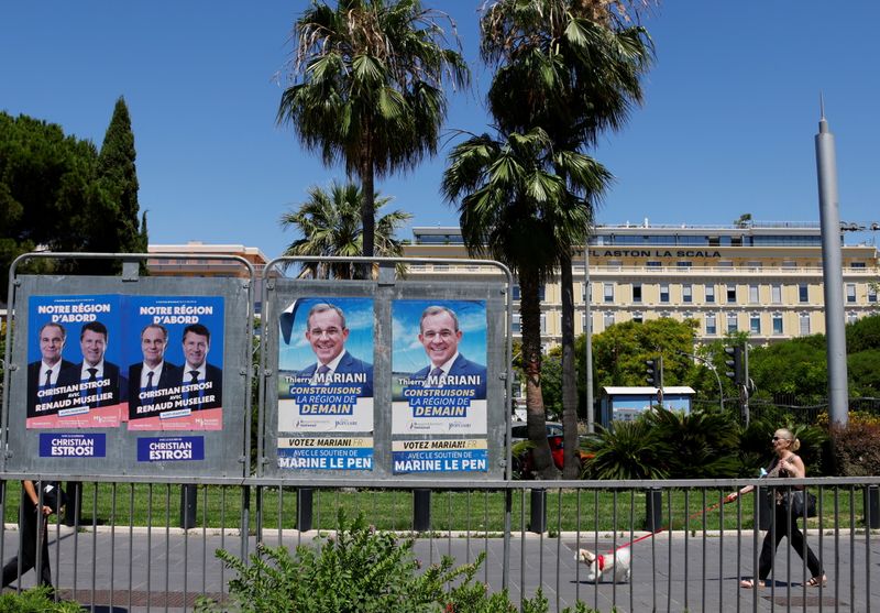 Electoral panels ahead of the second round of the French regional elections in Nice