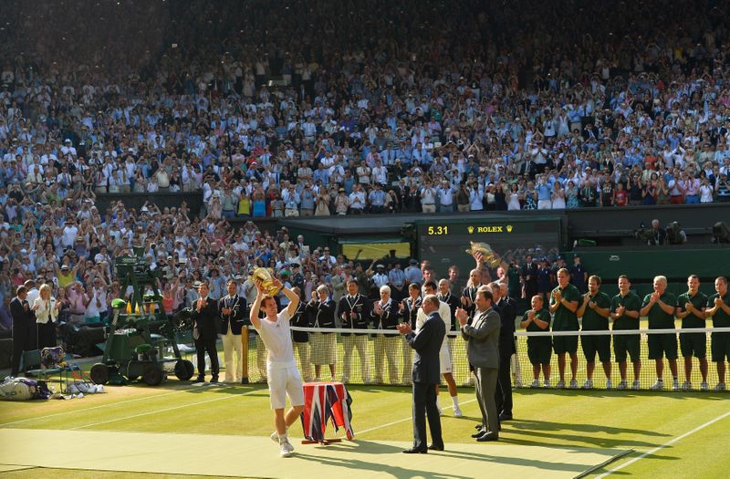 Andy Murray of Britain holds the winners trophy after defeating Novak Djokovic of Serbia in their men's singles final tennis match at the Wimbledon Tennis Championships, in London