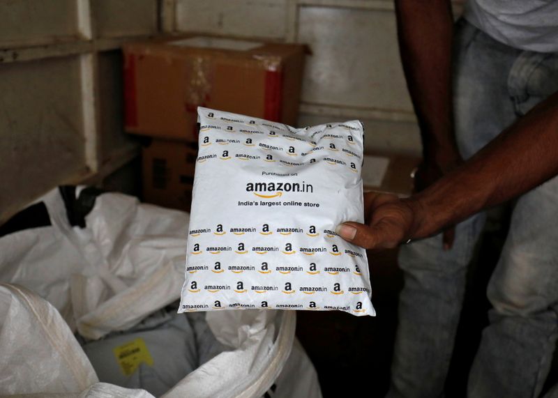 FILE PHOTO: A worker sorts delivery packages in a van outside an Amazon facility in Ahmedabad