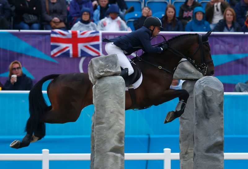 Australia's Andrew Hoy clears a fence during the Eventing jumping equestrian final at the London 2012 Olympic Games in Greenwich Park