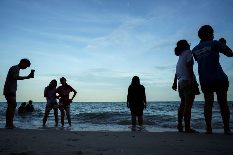 FILE PHOTO: People enjoy Cha-am Beach in Phetchaburi province