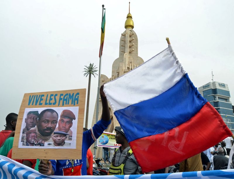 Malians hold an image with coup leader leader Goita during a pro-FAMA demonstration in Bamako