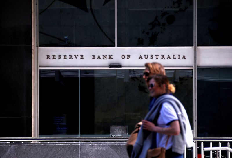 FILE PHOTO: Pedestrians walk past the main entrance to the Reserve Bank of Australia head office in central Sydney, Australia