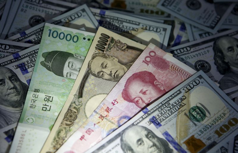 FILE PHOTO: South Korean won, Chinese yuan and Japanese yen notes are seen on U.S. 100 dollar notes in this picture illustration taken in Seoul