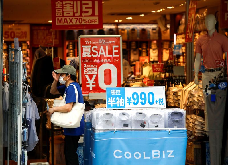A shopper wearing a protective face mask is seen at a shop selling office wear, amid the coronavirus disease (COVID-19) outbreak in Tokyo