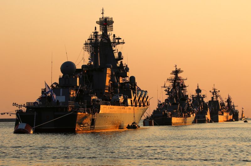 FILE PHOTO: A view shows Russian warships on sunset ahead of the Navy Day parade in the Black Sea port of Sevastopol