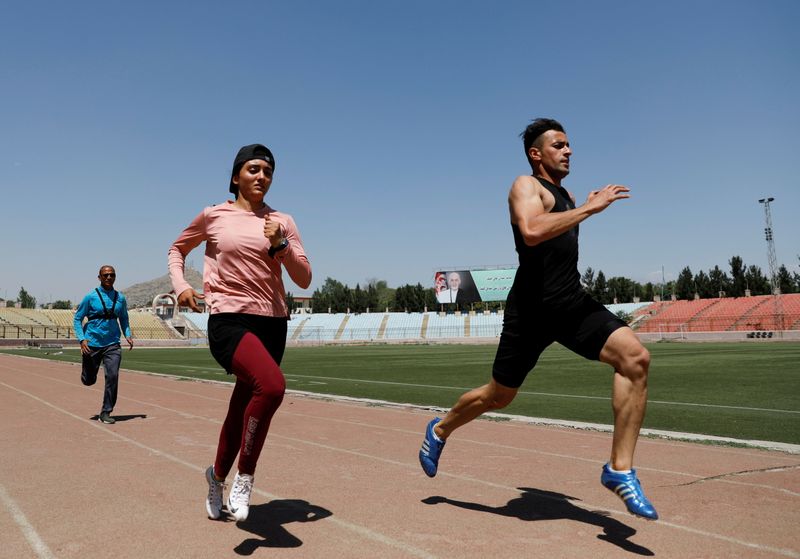 Afghan sprinters Kimia Yousofi, 25, and Sha Mahmood Noorzahi, 30, exercise ahead of 2020 Summer Olympics in Tokyo, at a stadium in Kabul