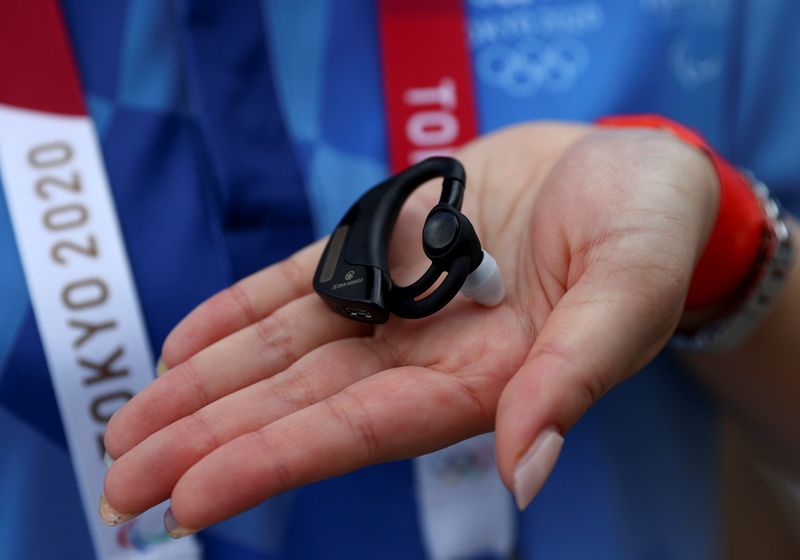 China's Alibaba provides ear-worn device to monitor temperature and heart rate of Olympics staff, in Tokyo