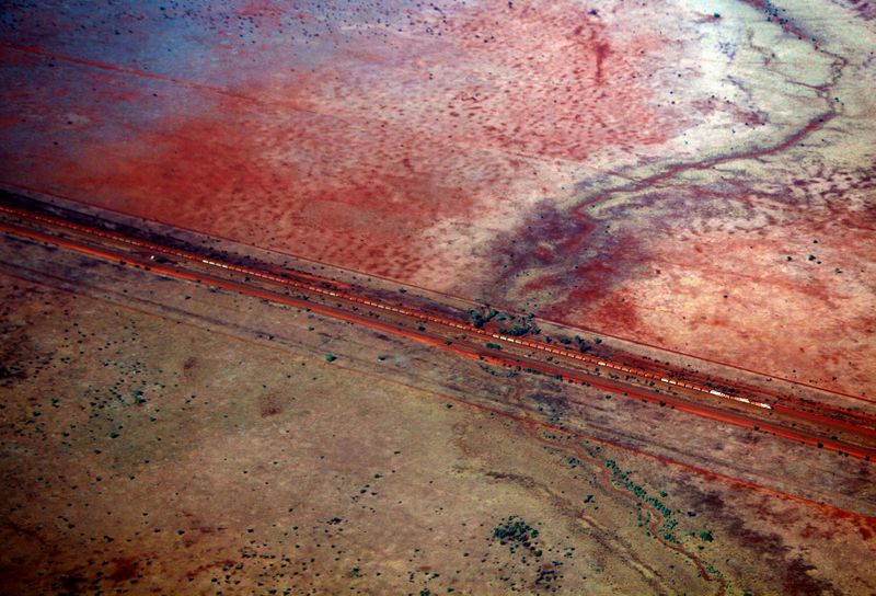 Train loaded with iron ore can be seen near Fortescue Solomon iron ore mine located in the Valley of the Kings