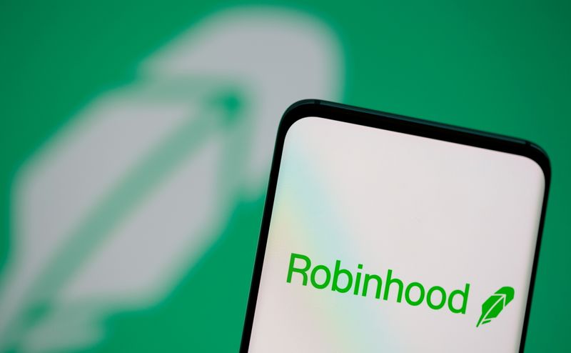 FILE PHOTO: Robinhood logo is seen on a smartphone in front of a displayed logo in this illustration