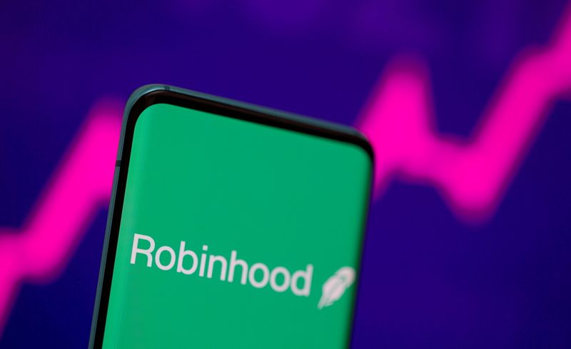 FILE PHOTO: Robinhood logo is seen on a smartphone in front of a displayed stock graph in this illustration taken