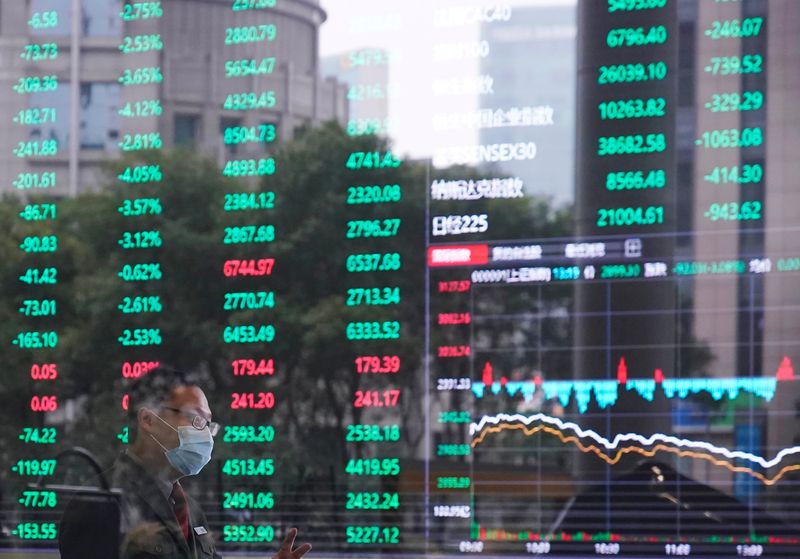 Man wearing a face mask is seen inside the Shanghai Stock Exchange building, as the country is hit by a novel coronavirus outbreak, at the Pudong financial district in Shanghai