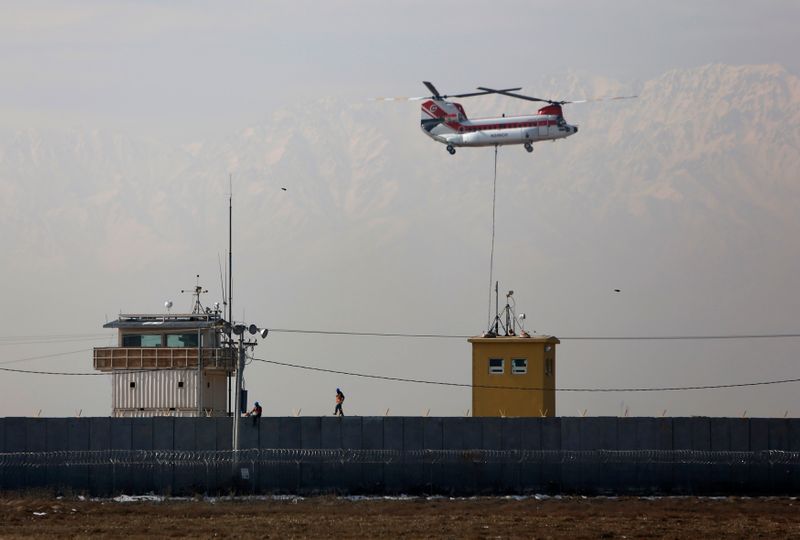 FILE PHOTO: Chinook helicopter flies over the Bagram Air Base north of Kabul