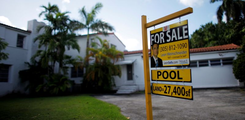 FILE PHOTO: A for sale sign sits outside a house in Miami Beach