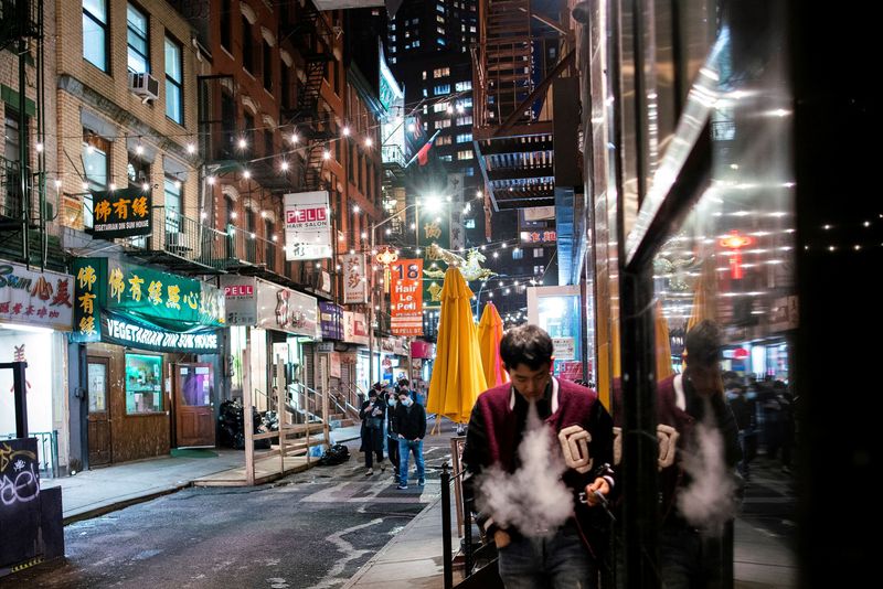 FILE PHOTO: People make their way in a local street of Chinatown in the Manhattan borough of New York