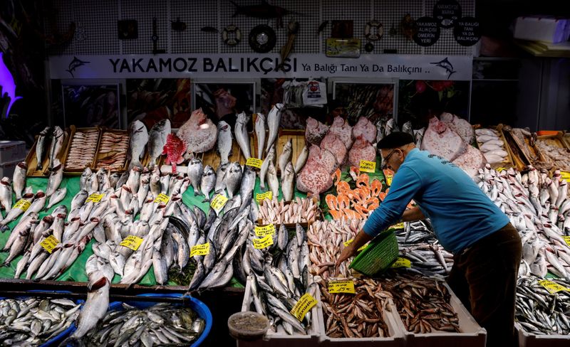 FILE PHOTO: People shop at a fish market at Karakoy district in Istanbul