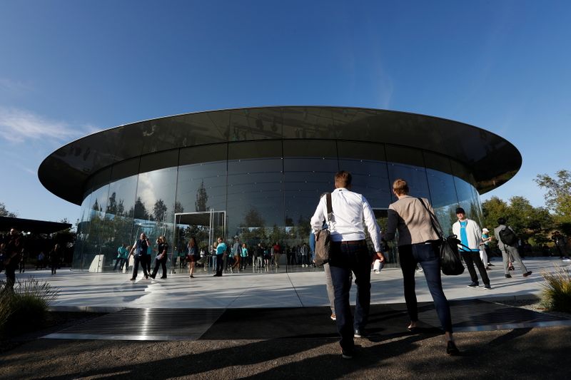 FILE PHOTO: Guests arrive for at the Steve Jobs Theater for an Apple event at their headquarters in Cupertino