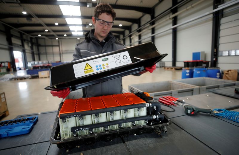 FILE PHOTO: A used Lithium-ion car battery is opened before its dismantling by an employee of the German recycling firm Accurec in Krefeld