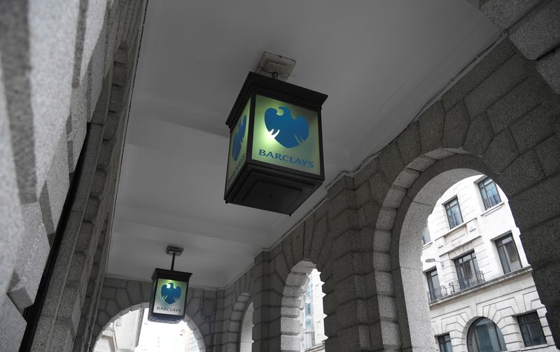 FILE PHOTO: The logo of Barclays bank is seen on glass lamps outside of a branch of the bank in the City of London financial district in London