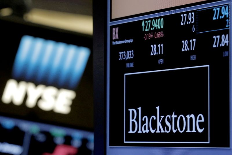 FILE PHOTO: The ticker and trading information for Blackstone Group is displayed at the post where it is traded on the floor of the New York Stock Exchange