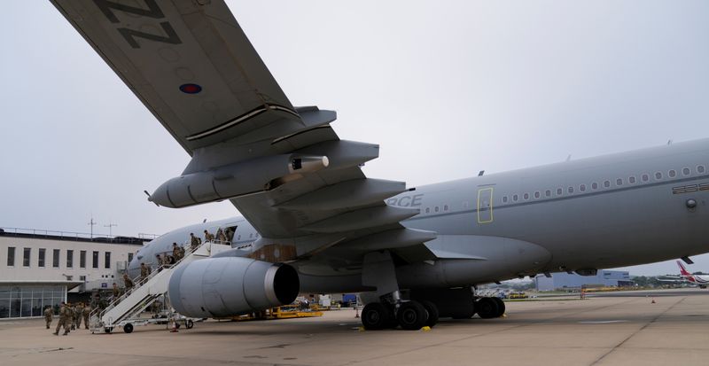 Members of the British armed forces 16 Air Assault Brigade disembark a RAF Voyager aircraft after landing at Brize Norton