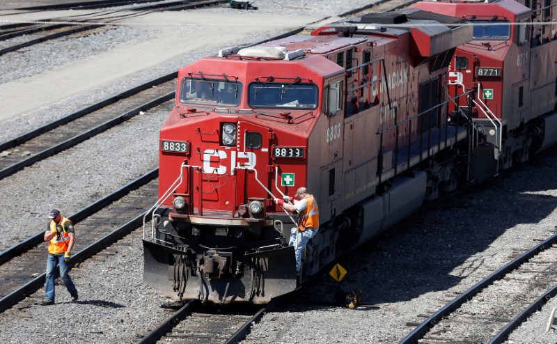 FILE PHOTO: A Canadian Pacific Railway crew works on their train at the CP Rail yards in Calgary