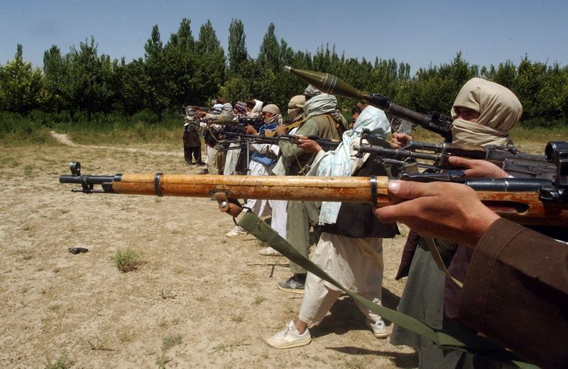 FILE PHOTO: Taliban fighters train with their weapons in an undisclosed location in Afghanistan