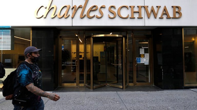 Charles Schwab boosts pay, delays return to office