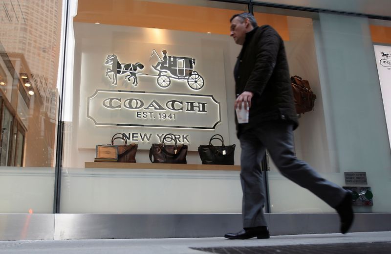 FILE PHOTO: A man walks past a Coach store on Madison Avenue in New York