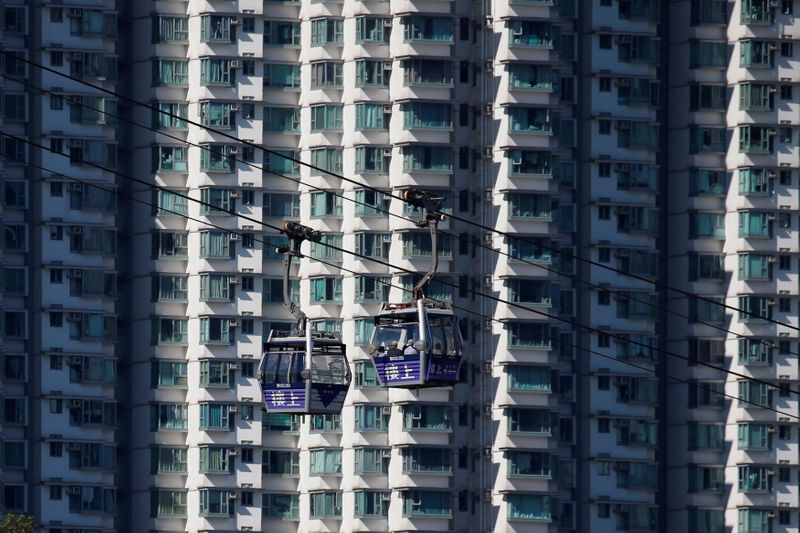 Cable cars move past residential flats at Lantau island in Hong Kong