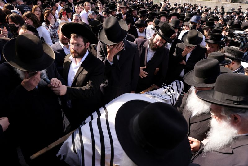 FILE PHOTO: Ultra-Orthodox Jewish men take part in a funeral for Rabbi Elazar Goldberg in Jerusalem