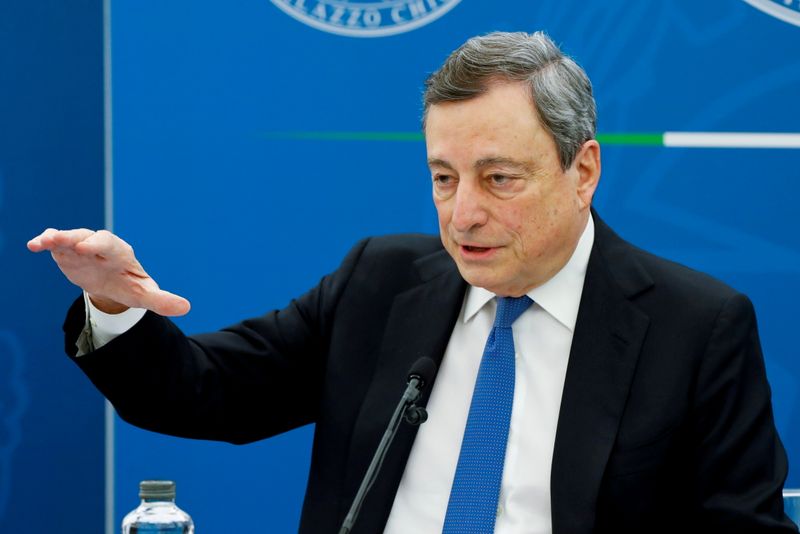 FILE PHOTO: Italy's Prime Minister Mario Draghi gestures as he speaks at a news conference where he is expected to map out the country's next moves in loosening coronavirus disease (COVID-19) restrictions, in Rome, Italy, April 16
