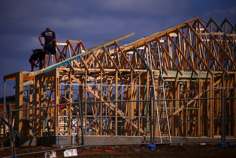 Tradesmen can be seen working on the roof of a house under construction at a housing development located in the western Sydney suburb of Oran Park