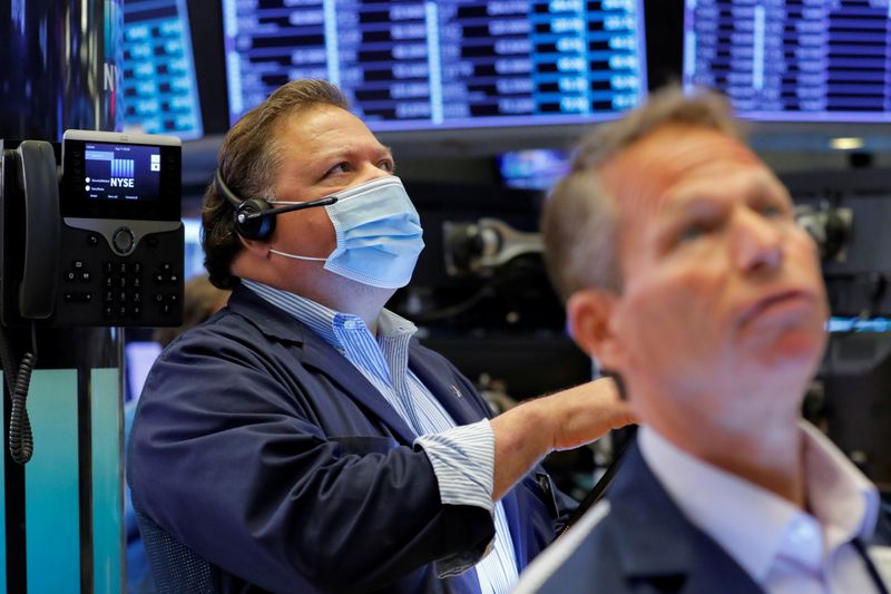 Traders work on the trading floor at the New York Stock Exchange (NYSE) in Manhattan, New York City